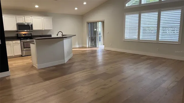 a kitchen with stainless steel appliances granite countertop a stove top oven a sink dishwasher and a microwave oven on granite countertops