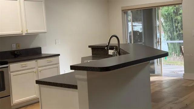 a kitchen with a sink and cabinets