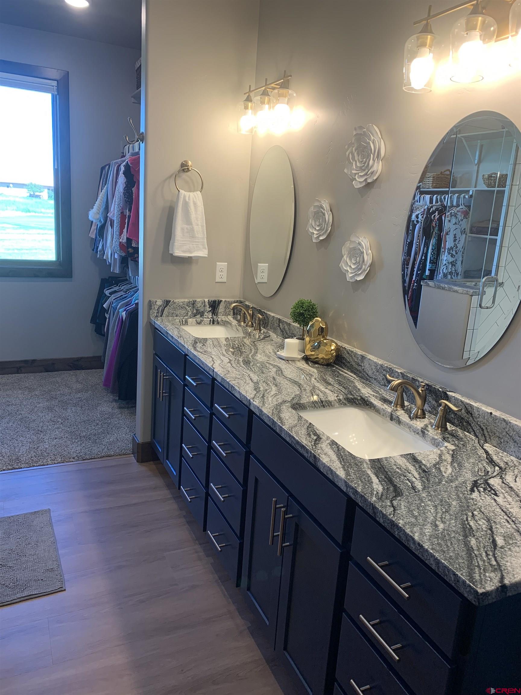 2533 Bear Lake Drive Montrose, CO 81401 - Photo 20 of 34 a bathroom with a granite countertop double vanity sink and a mirror