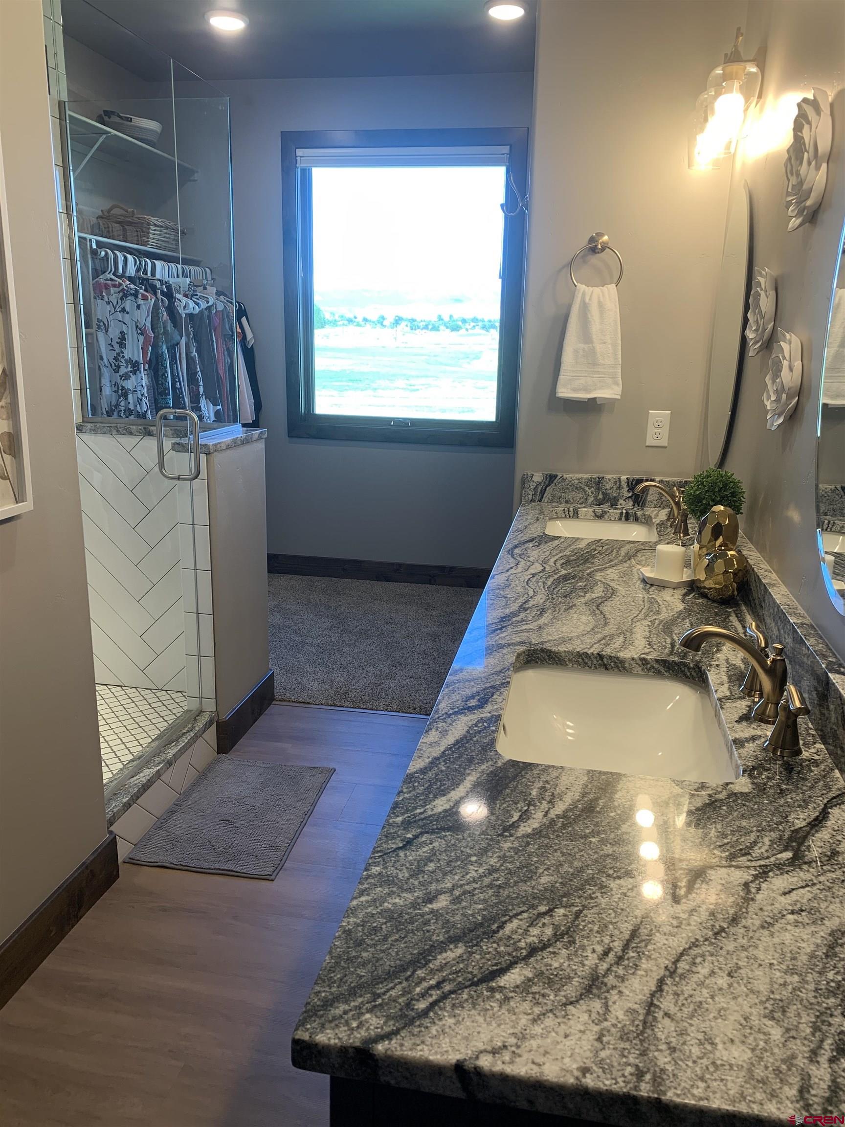 2533 Bear Lake Drive Montrose, CO 81401 - Photo 24 of 34 a bedroom with a bed and a mirror