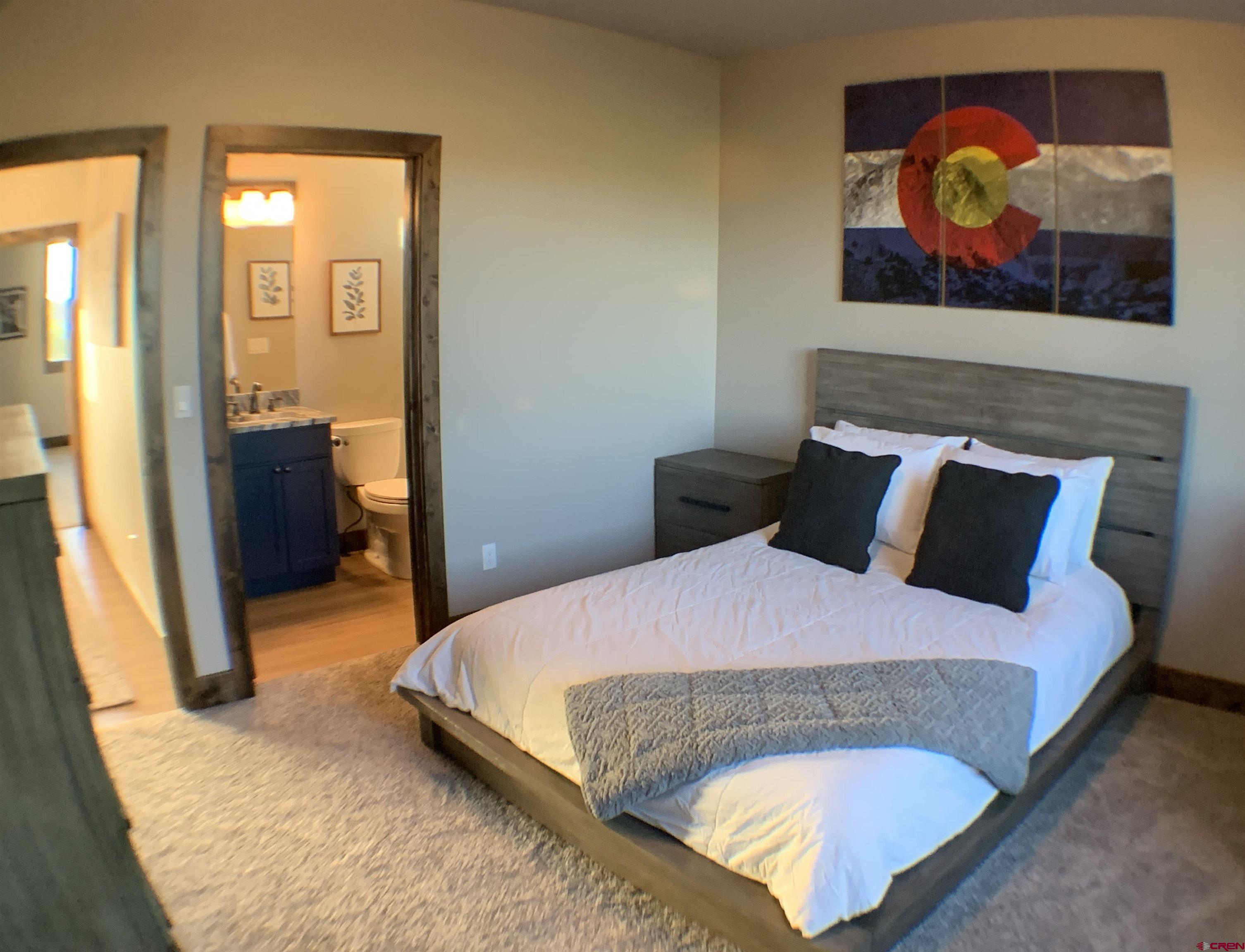 2533 Bear Lake Drive Montrose, CO 81401 - Photo 26 of 34 a bedroom with a bed and painting on the wall