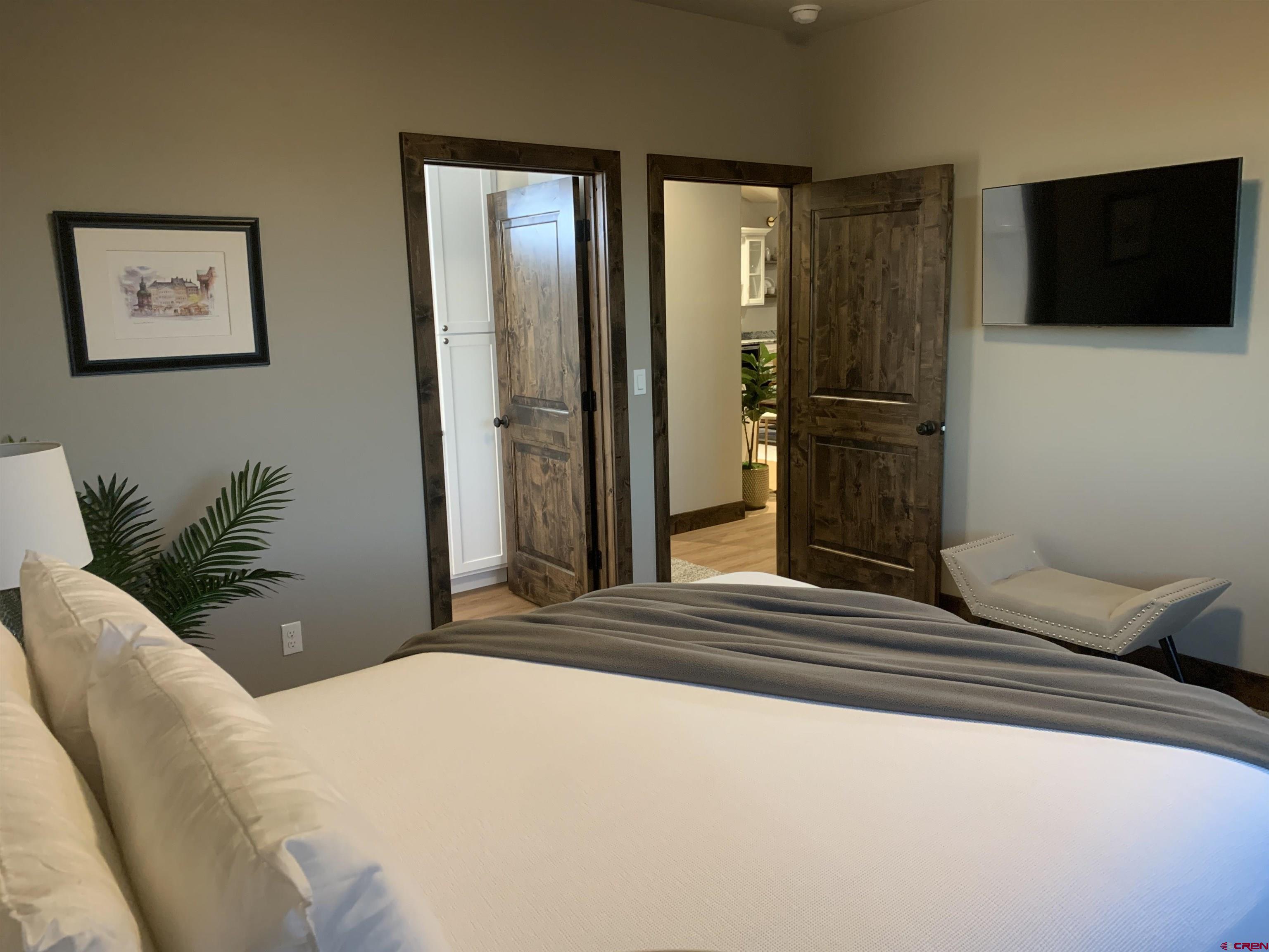 2533 Bear Lake Drive Montrose, CO 81401 - Photo 30 of 34 a bedroom with a bed a television and potted plant