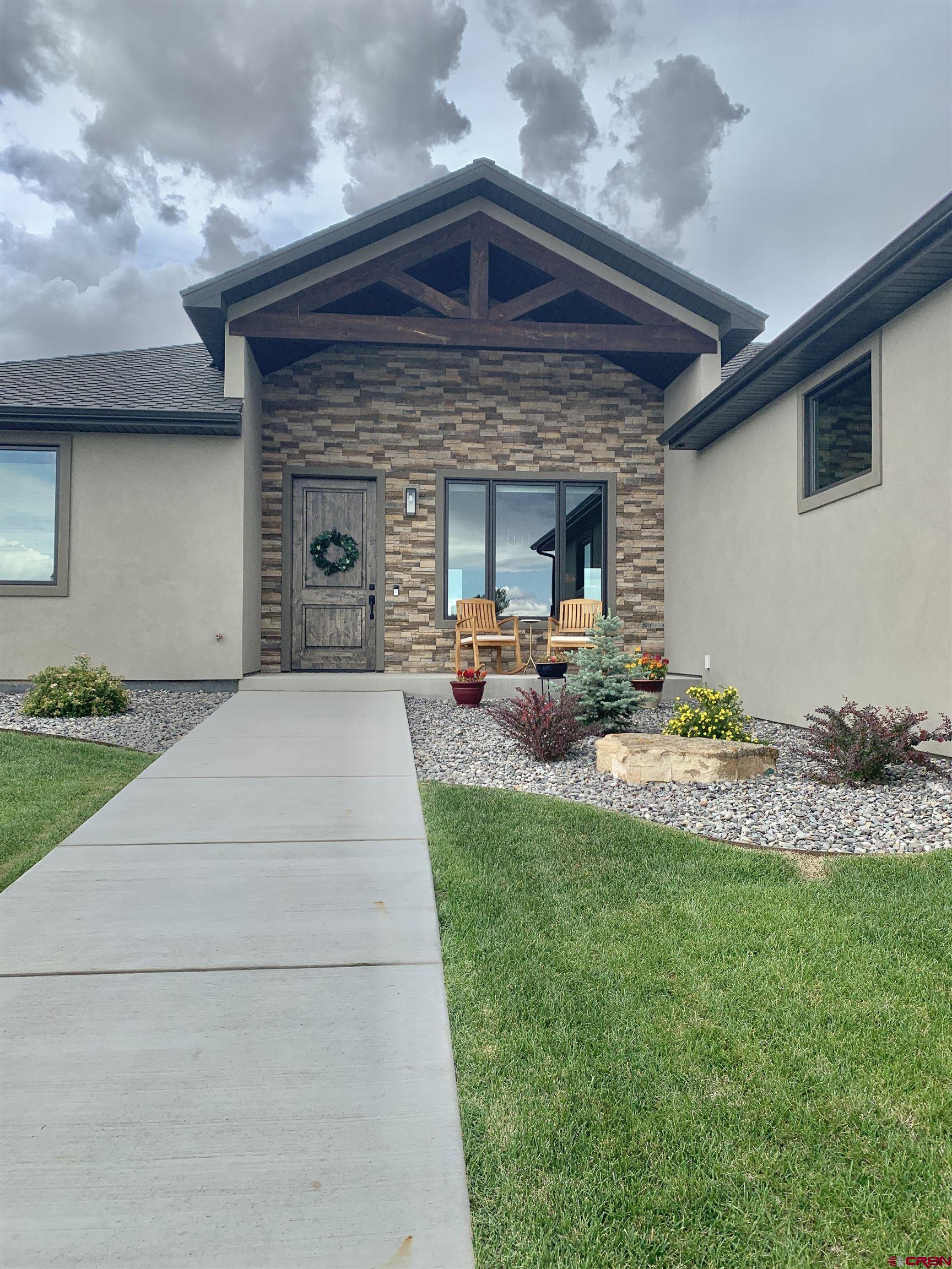 2533 Bear Lake Drive Montrose, CO 81401 - Photo 33 of 34 a front view of a house with garden