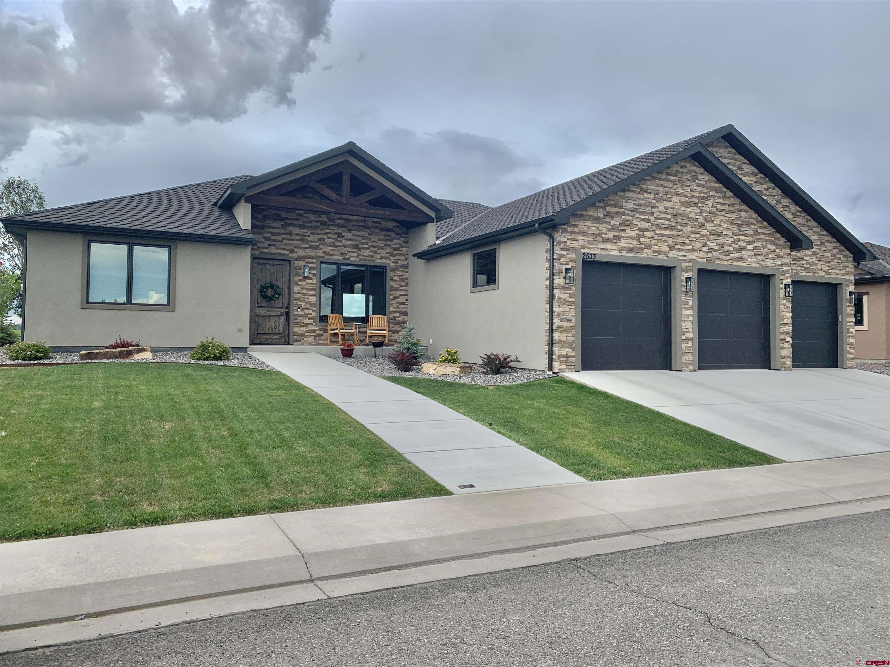 2533 Bear Lake Drive Montrose, CO 81401 - Photo 34 of 34 a view of a house with a yard and garage