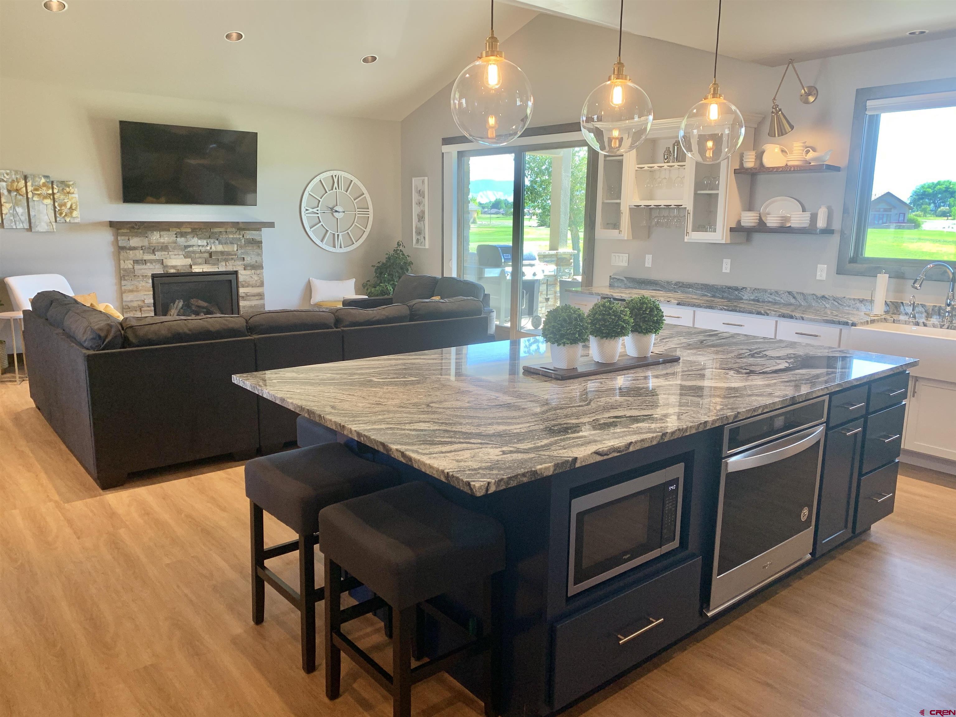 2533 Bear Lake Drive Montrose, CO 81401 - Photo 5 of 34 a kitchen with a stove and a wooden floor