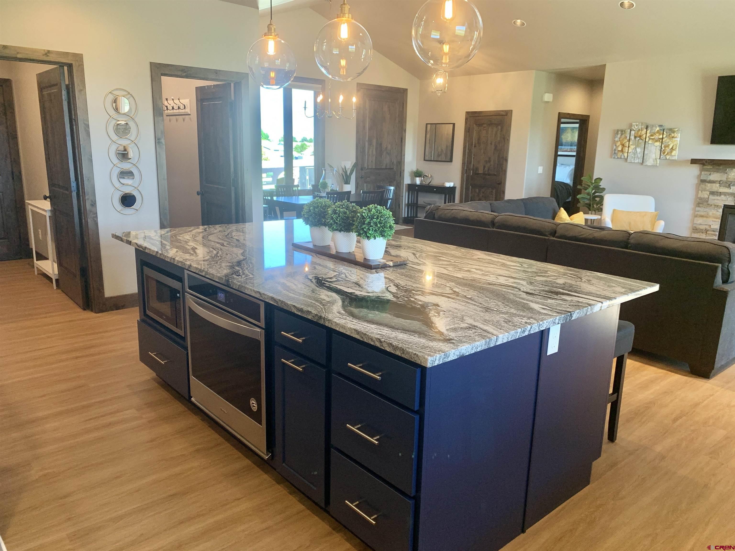 2533 Bear Lake Drive Montrose, CO 81401 - Photo 6 of 34 a kitchen with granite countertop counter space a sink and a refrigerator
