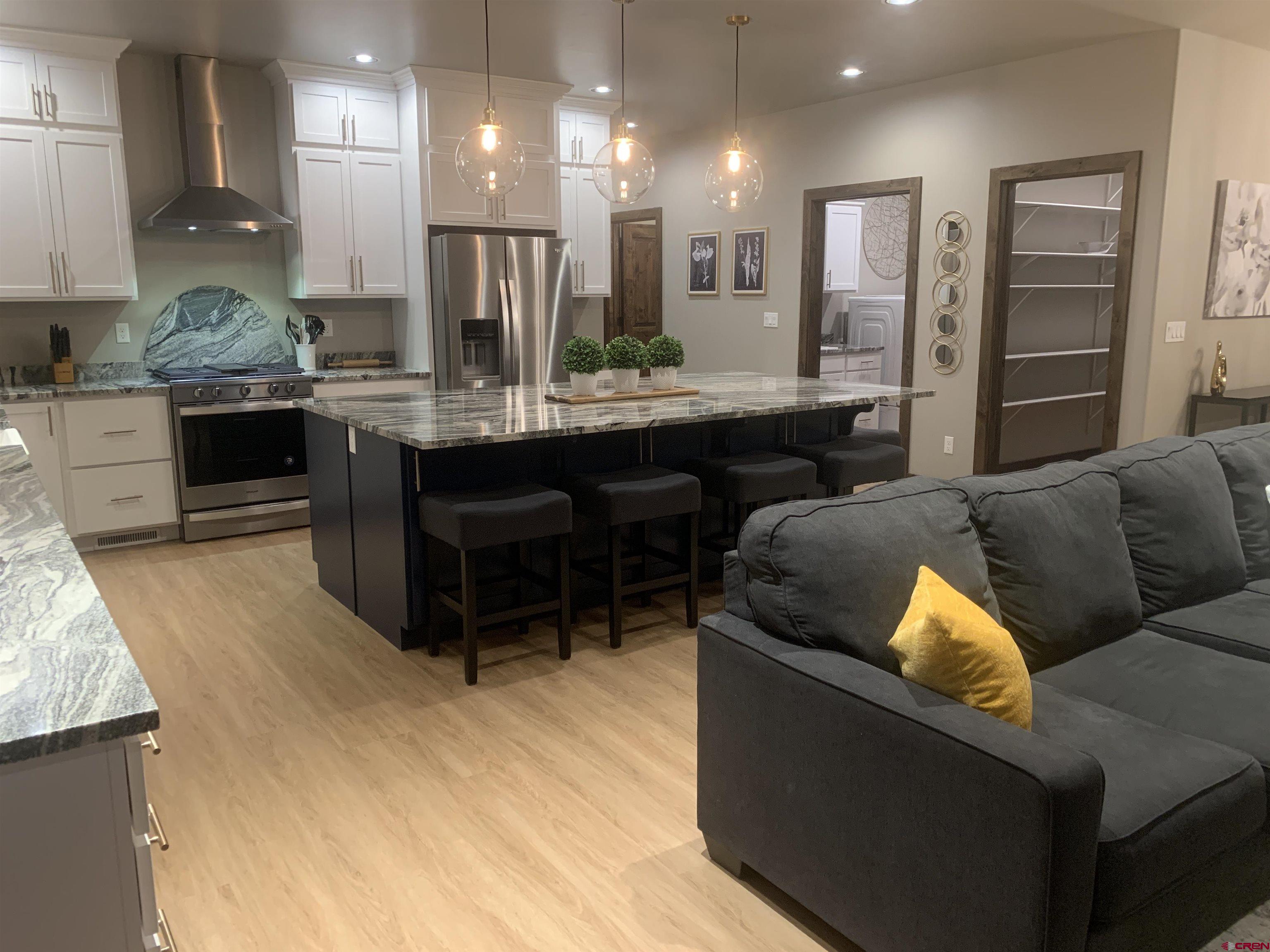 2533 Bear Lake Drive Montrose, CO 81401 - Photo 7 of 34 a living room with stainless steel appliances kitchen island granite countertop furniture and a large window