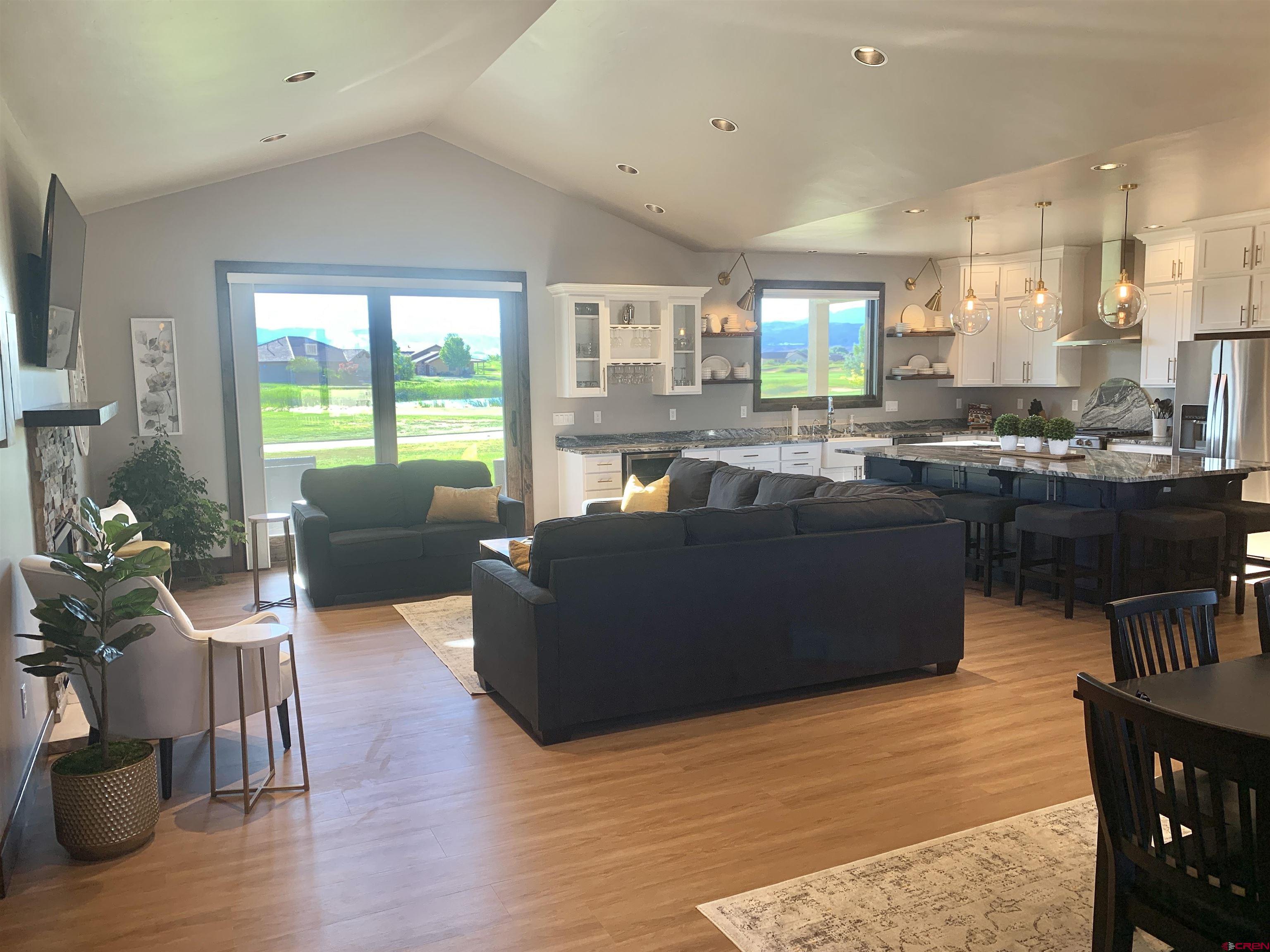 2533 Bear Lake Drive Montrose, CO 81401 - Photo 8 of 34 a living room with kitchen island furniture and a large window