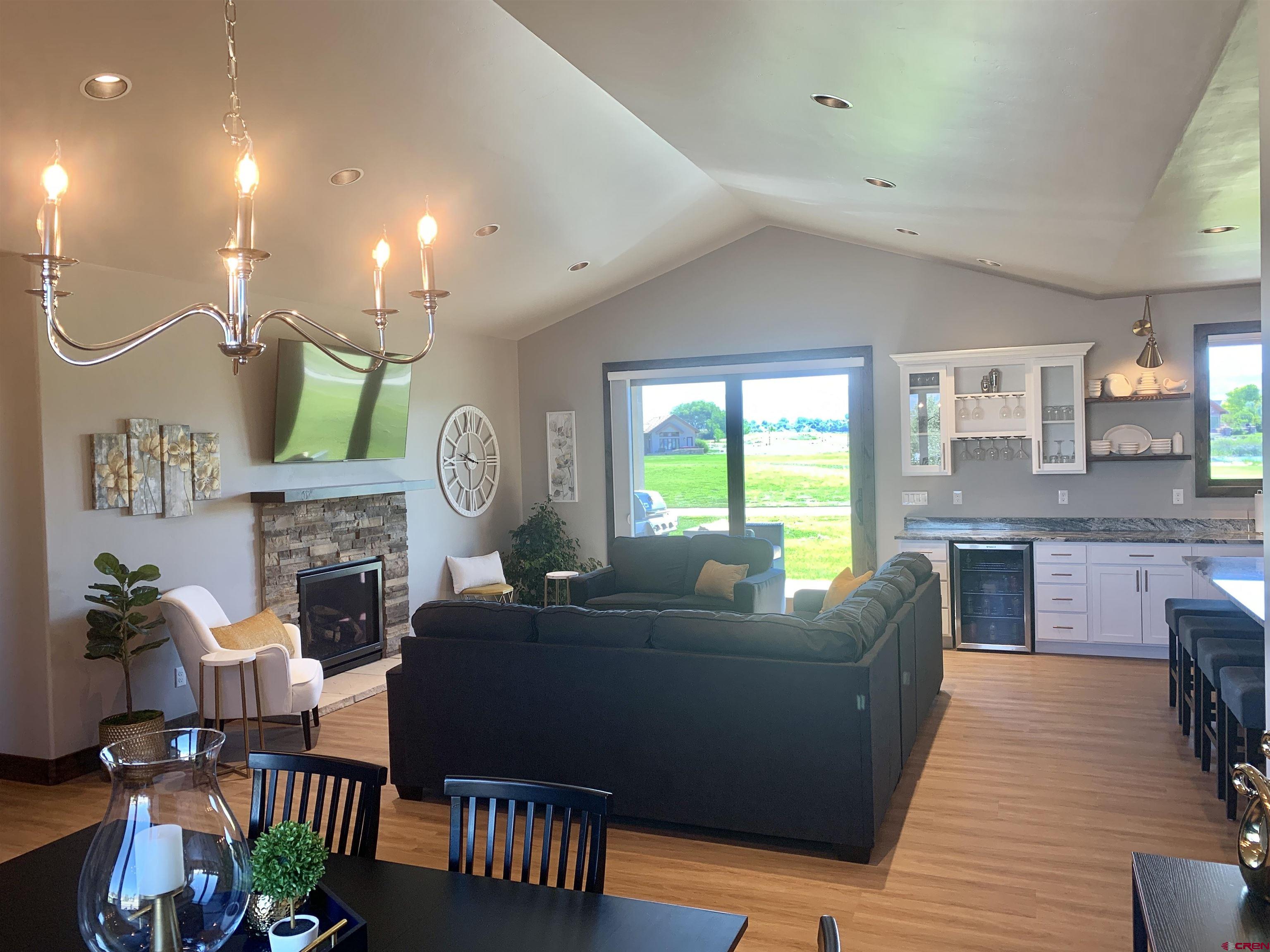 2533 Bear Lake Drive Montrose, CO 81401 - Photo 9 of 34 a living room with fireplace furniture and a wooden floor