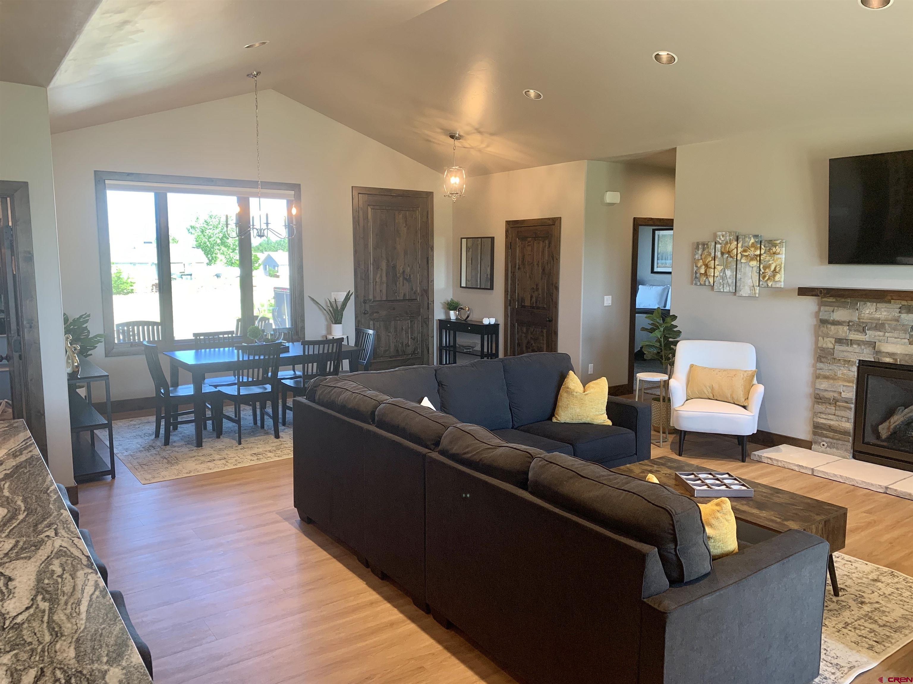 2533 Bear Lake Drive Montrose, CO 81401 - Photo 10 of 34 a living room with fireplace furniture and a flat screen tv