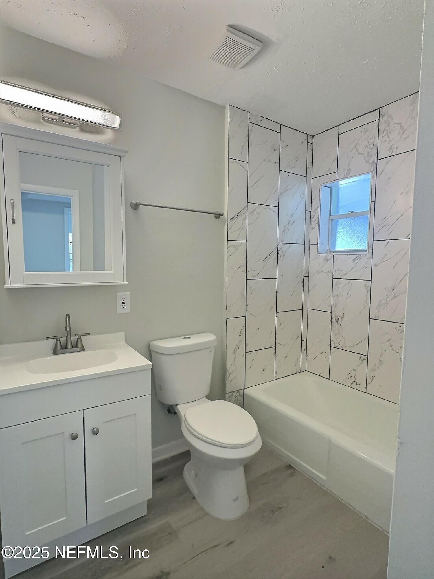 7456 Centauri Road Jacksonville, FL 32210 - Photo 17 of 26 a bathroom with a sink a toilet and shower