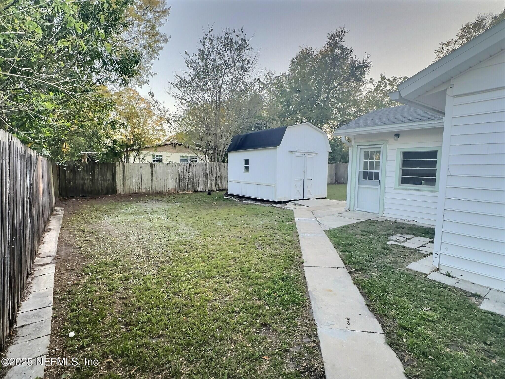 7456 Centauri Road Jacksonville, FL 32210 - Photo 23 of 26 a view of a front of a house with a yard