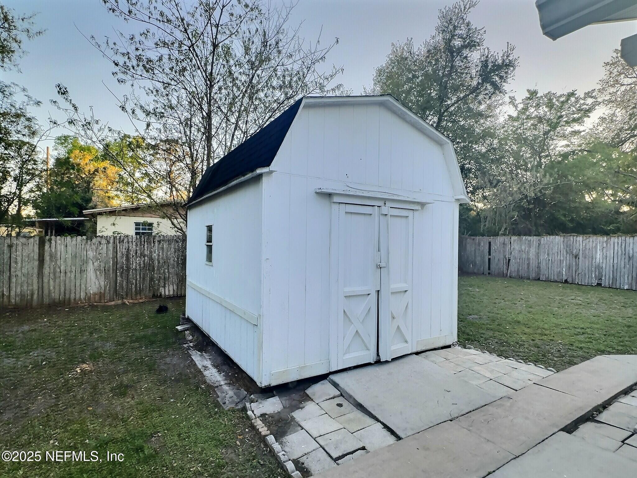 7456 Centauri Road Jacksonville, FL 32210 - Photo 24 of 26 a view of backyard of house with wooden fence