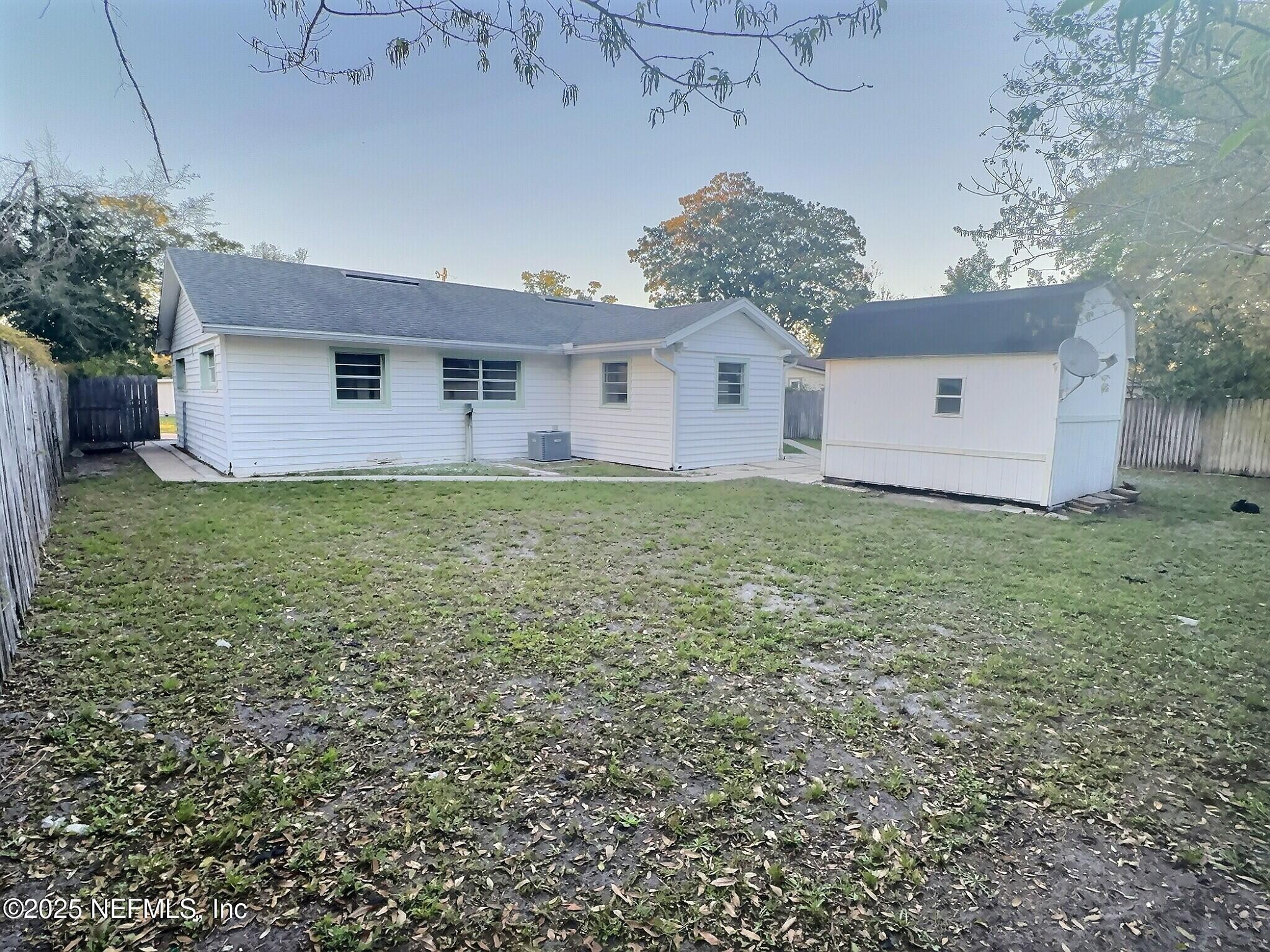 7456 Centauri Road Jacksonville, FL 32210 - Photo 26 of 26 a house that is sitting in the grass with large trees