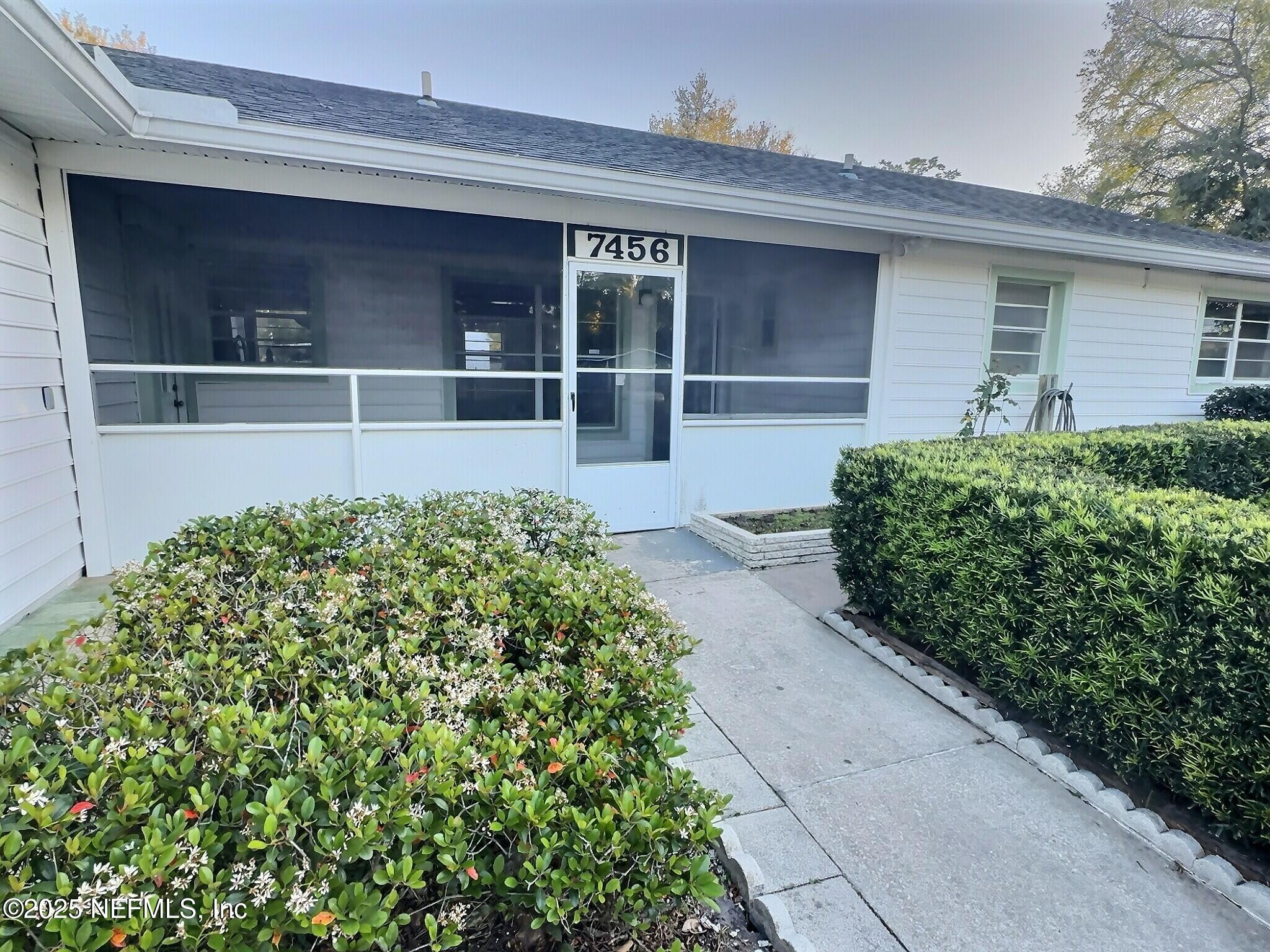 7456 Centauri Road Jacksonville, FL 32210 - Photo 3 of 26 a view of a house with a flower garden