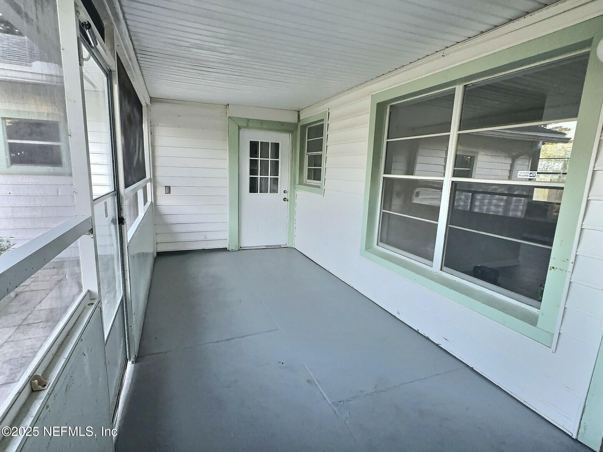 7456 Centauri Road Jacksonville, FL 32210 - Photo 4 of 26 a view of empty room with windows
