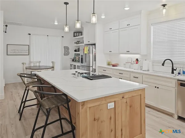 a kitchen with cabinets a sink and appliances