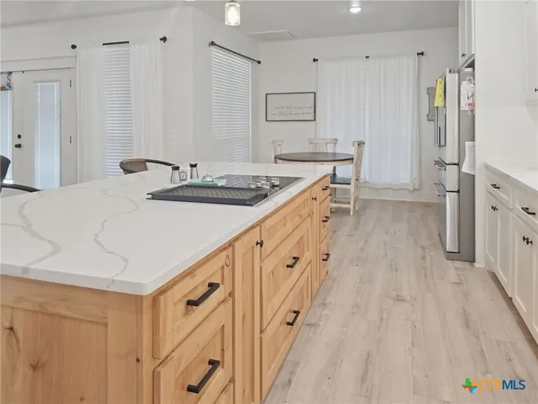 a kitchen with stainless steel appliances kitchen island granite countertop a sink stove and cabinets