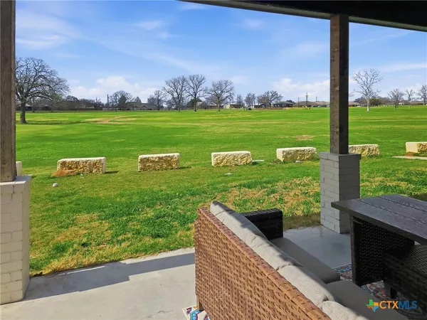 a living room with furniture a flat screen tv and a table