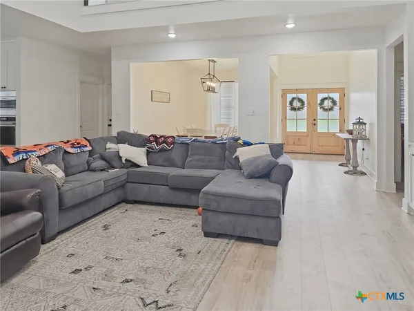 a living room with furniture and kitchen view