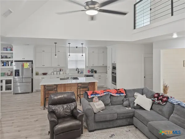 a living room with furniture and a wooden floor