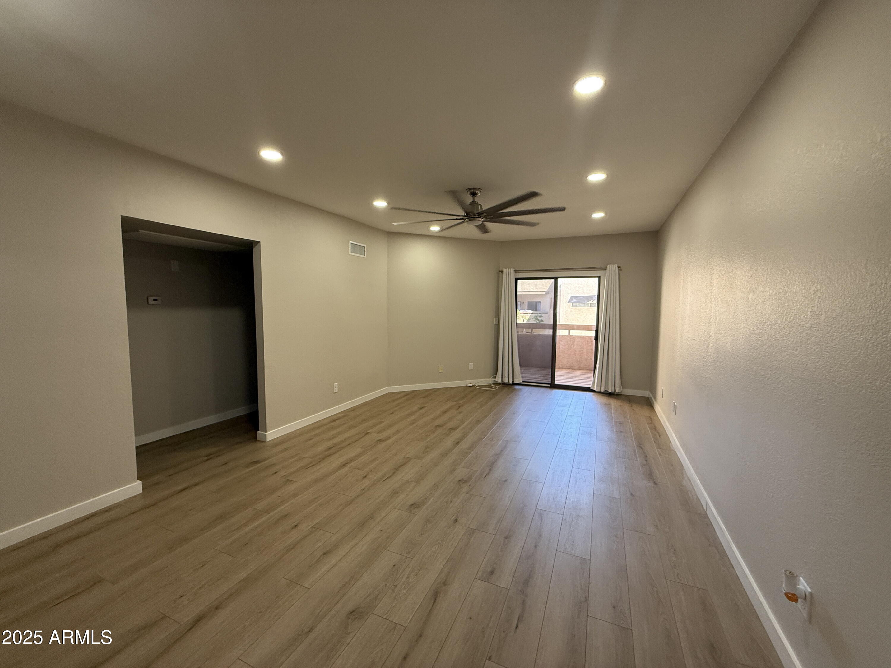 1287 North Alma School Road, Unit 207 Chandler, AZ 85224 - Photo 9 of 9 a view of empty room with window and wooden floor