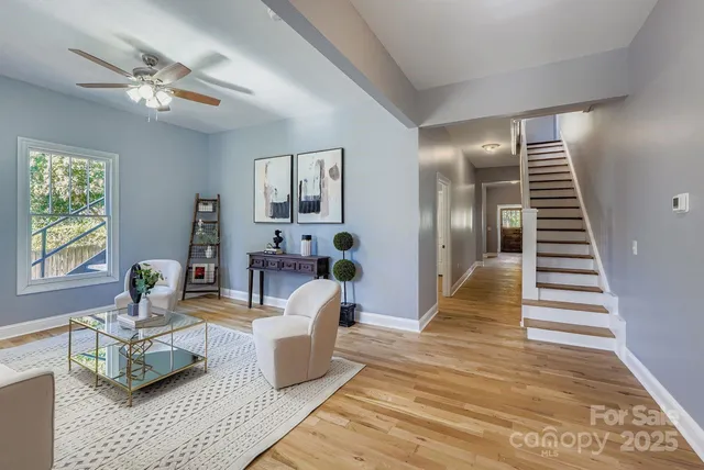 a living room with furniture and wooden floor