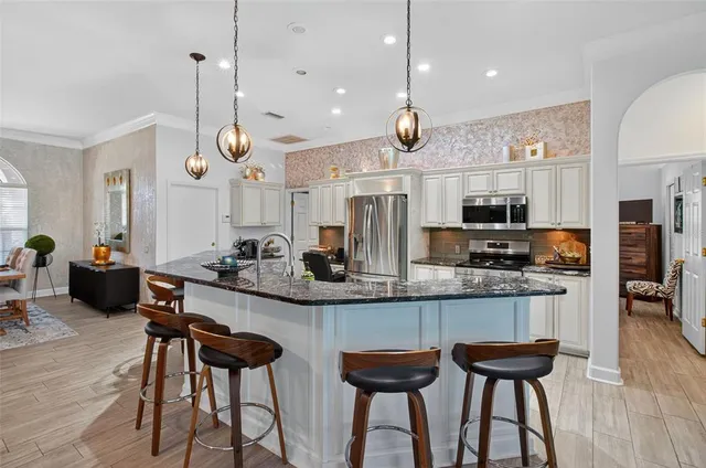 a living room with furniture and a floor to ceiling window