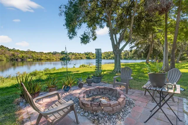 a living room with furniture kitchen view and a chandelier