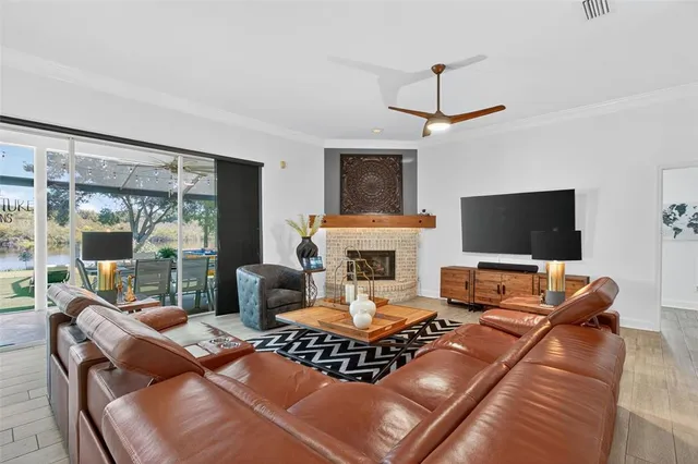 a dining room with furniture a chandelier and wooden floor