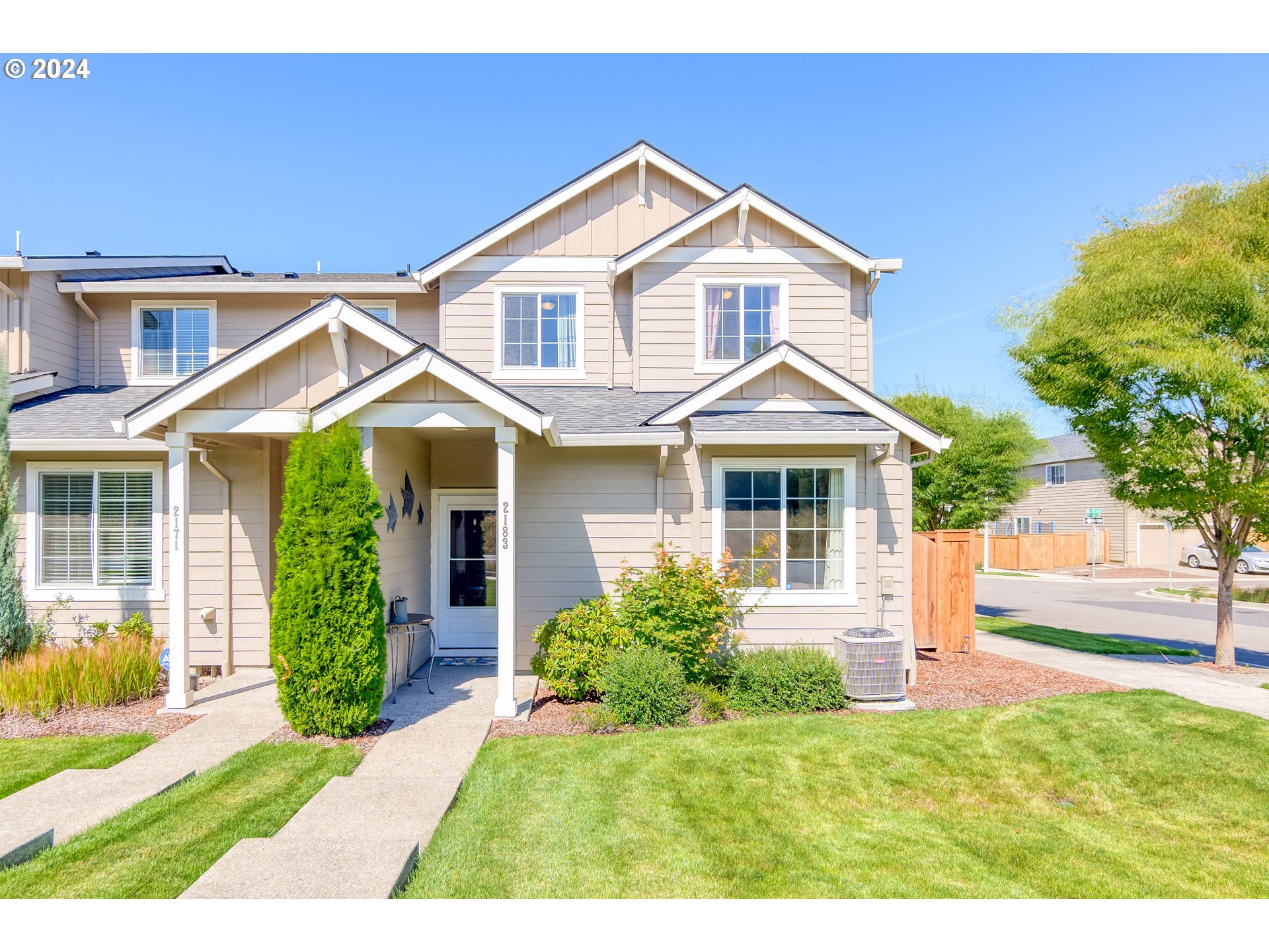 2183 Southeast 19th Street Gresham, OR 97080 - Photo 1 of 26 a front view of a house with a yard and potted plants