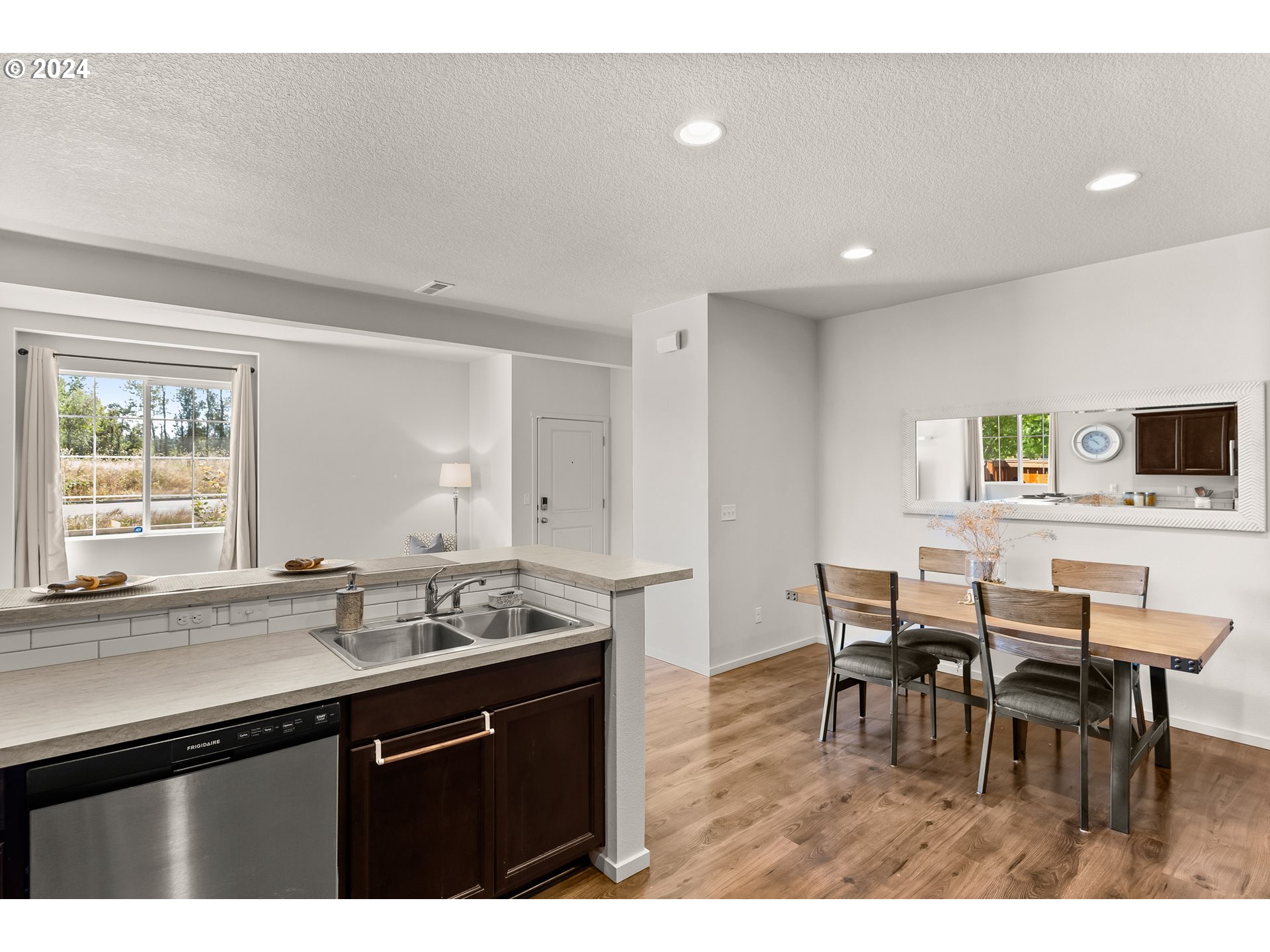 2183 Southeast 19th Street Gresham, OR 97080 - Photo 11 of 26 a kitchen with a dining table chairs and white appliances