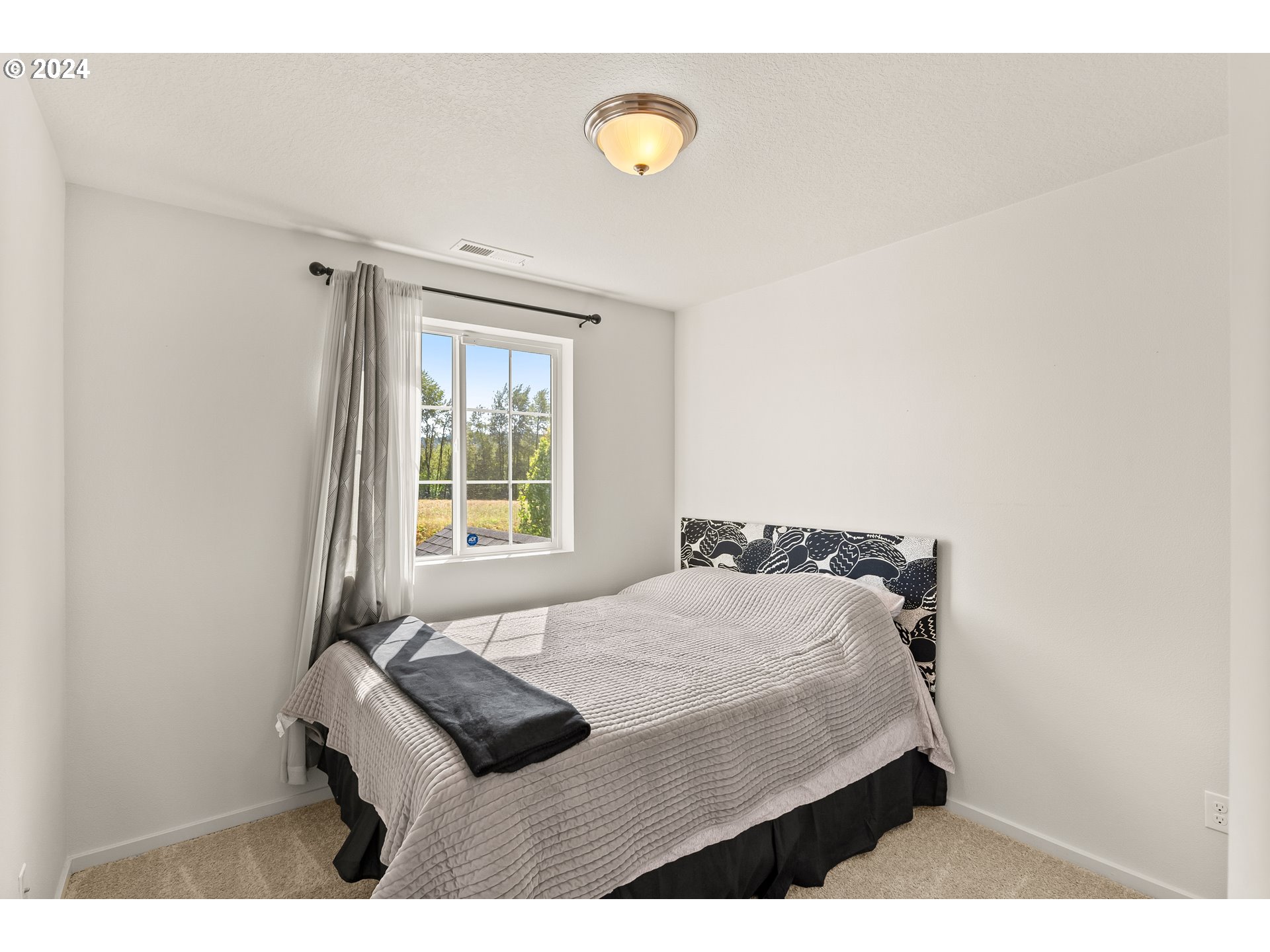 2183 Southeast 19th Street Gresham, OR 97080 - Photo 22 of 26 a bedroom with a bed and a window