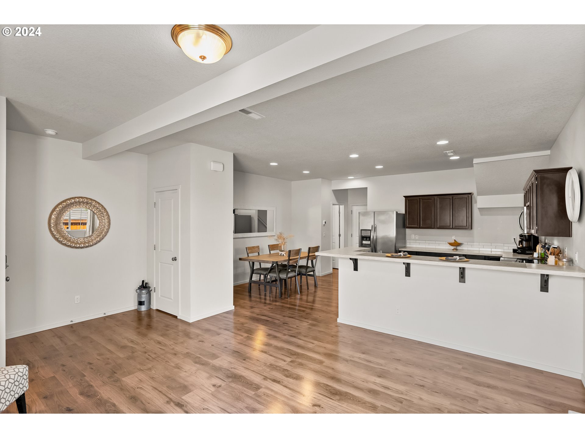 2183 Southeast 19th Street Gresham, OR 97080 - Photo 6 of 26 a view of a living room and kitchen with furniture wooden floor and a rug
