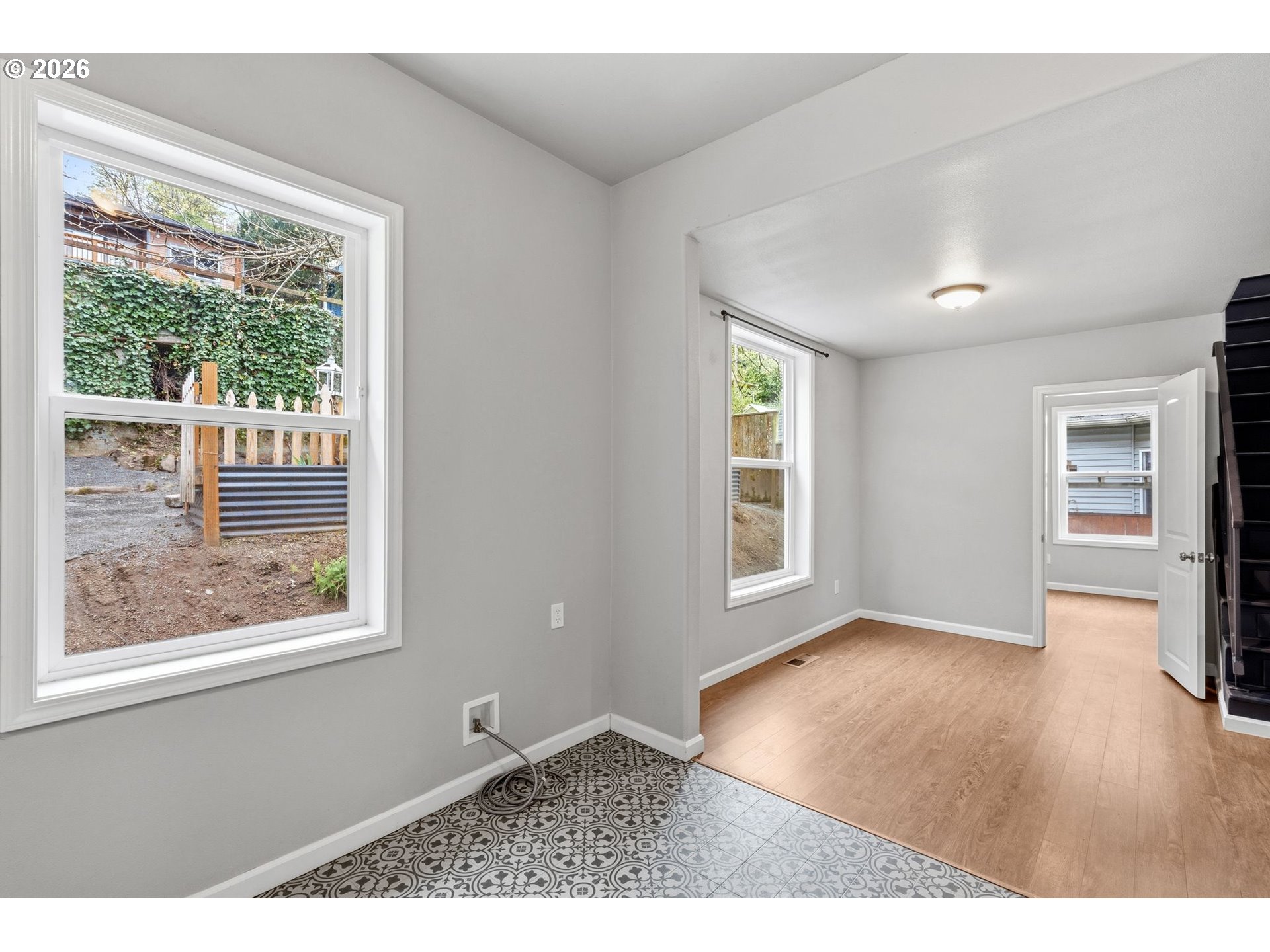10505 Northwest 2nd Street Portland, OR 97231 - Photo 11 of 39 an empty room with wooden floor and windows