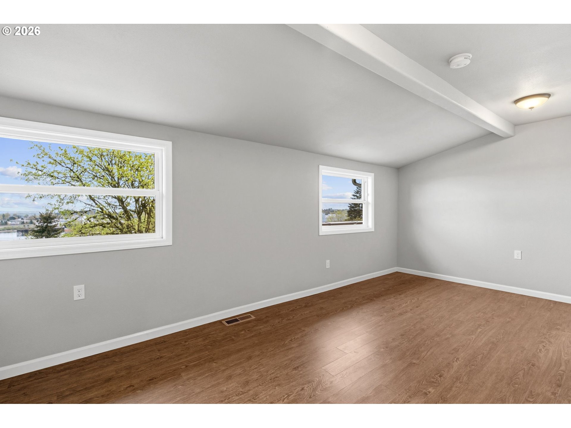 10505 Northwest 2nd Street Portland, OR 97231 - Photo 17 of 39 an empty room with wooden floor and windows