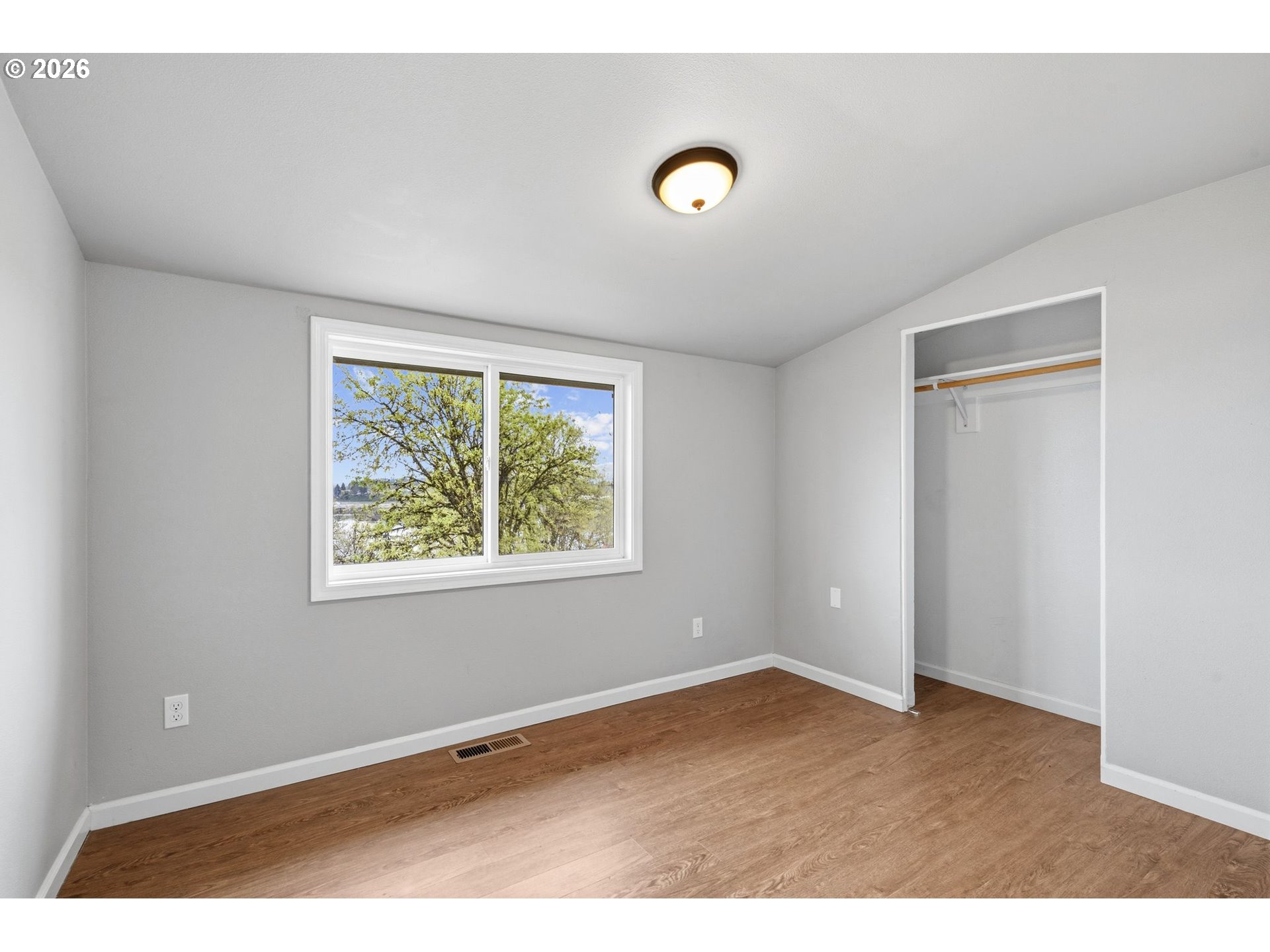 10505 Northwest 2nd Street Portland, OR 97231 - Photo 20 of 39 a view of an empty room with wooden floor and a window