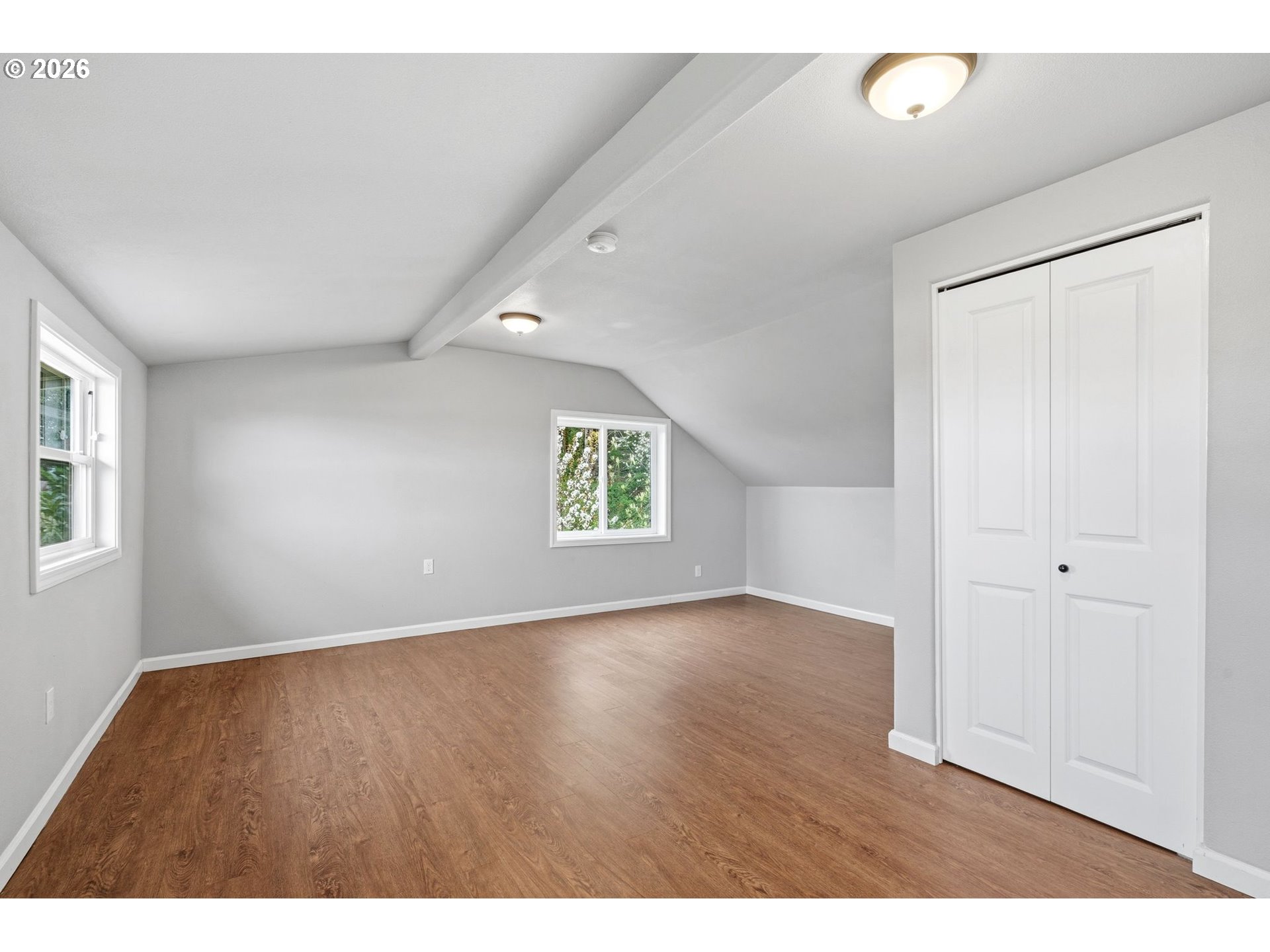 10505 Northwest 2nd Street Portland, OR 97231 - Photo 21 of 39 a view of an empty room with wooden floor and a window