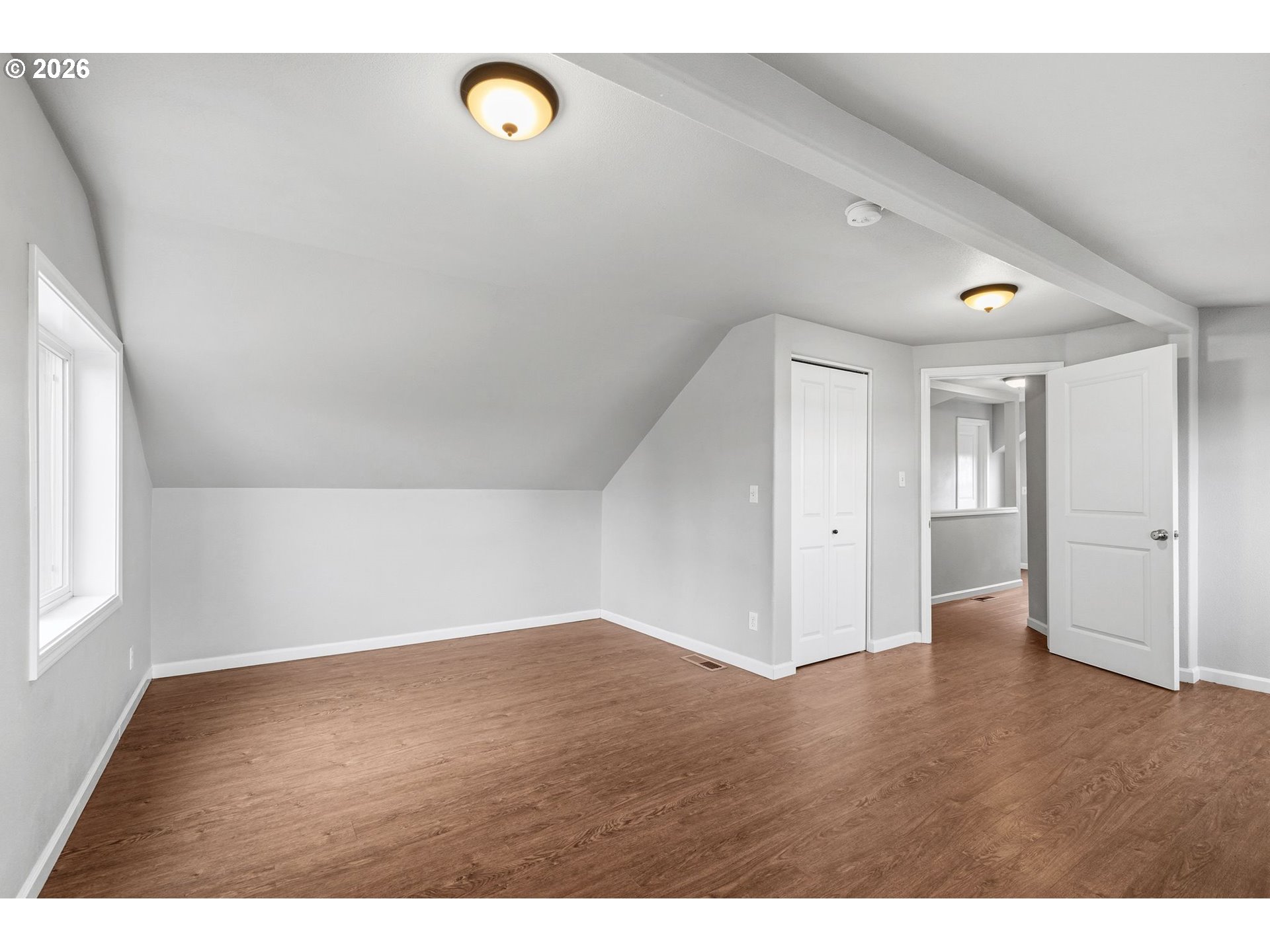 10505 Northwest 2nd Street Portland, OR 97231 - Photo 22 of 39 a view of an empty room with window and wooden floor