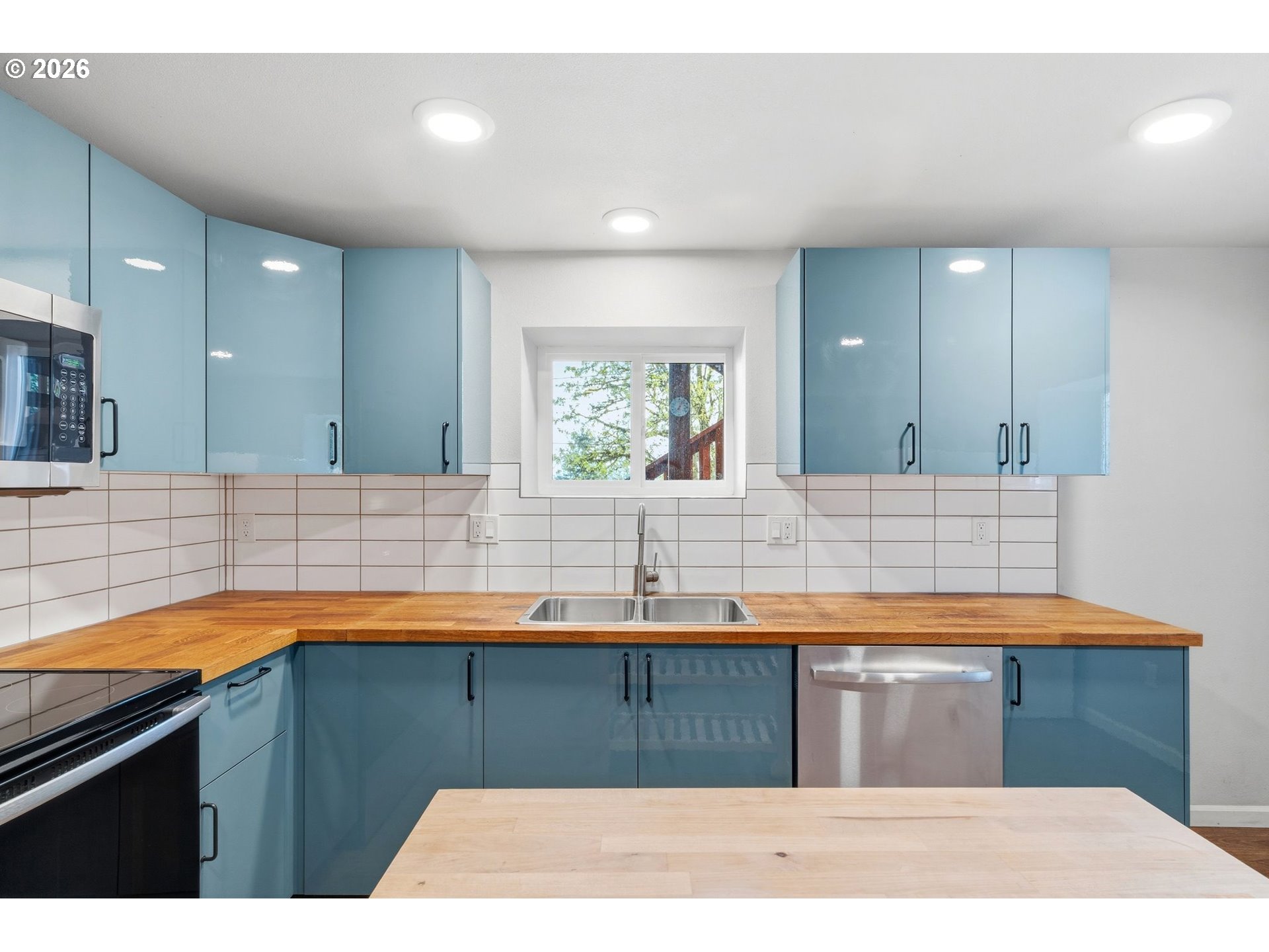 10505 Northwest 2nd Street Portland, OR 97231 - Photo 28 of 39 a kitchen with a sink cabinets and a wooden floor
