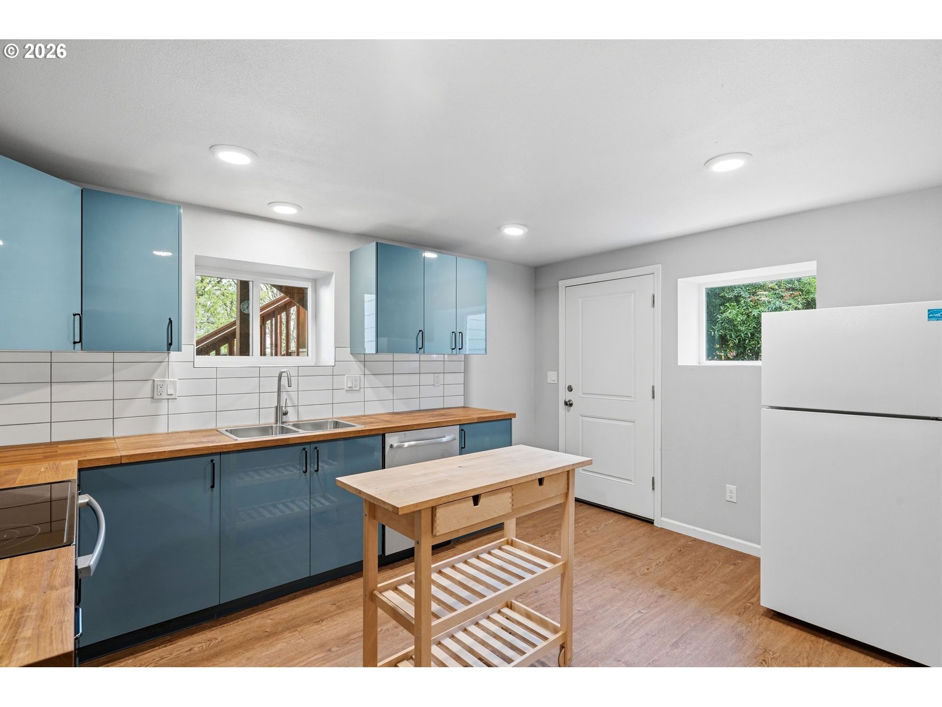 10505 Northwest 2nd Street Portland, OR 97231 - Photo 29 of 39 a kitchen with a sink cabinets and wooden floor