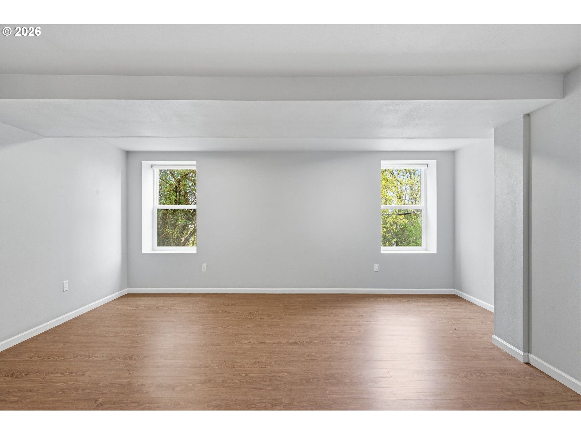 10505 Northwest 2nd Street Portland, OR 97231 - Photo 34 of 39 an empty room with wooden floor and windows