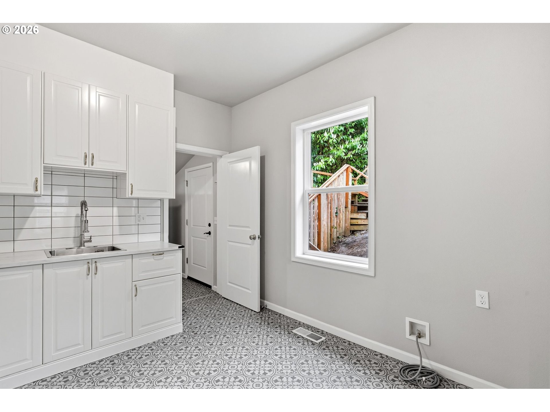 10505 Northwest 2nd Street Portland, OR 97231 - Photo 5 of 39 a kitchen with white cabinets and window