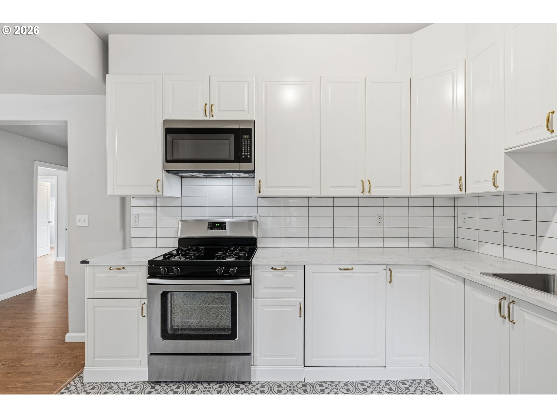 10505 Northwest 2nd Street Portland, OR 97231 - Photo 7 of 39 a kitchen with cabinets stainless steel appliances and a sink