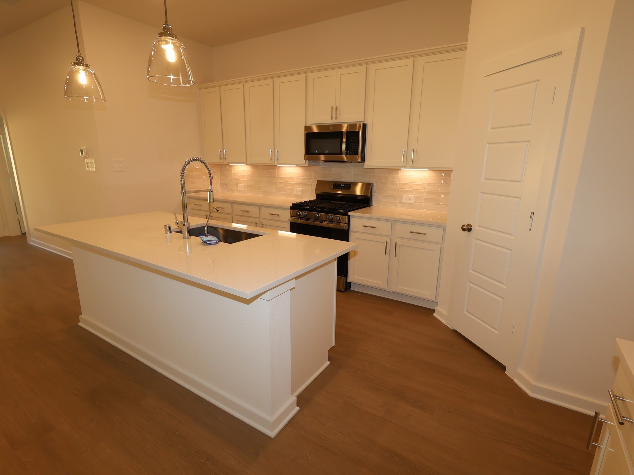 957 Garden Path Drive Willis, TX 77378 - Photo 12 of 37 a kitchen with a sink a stove and refrigerator