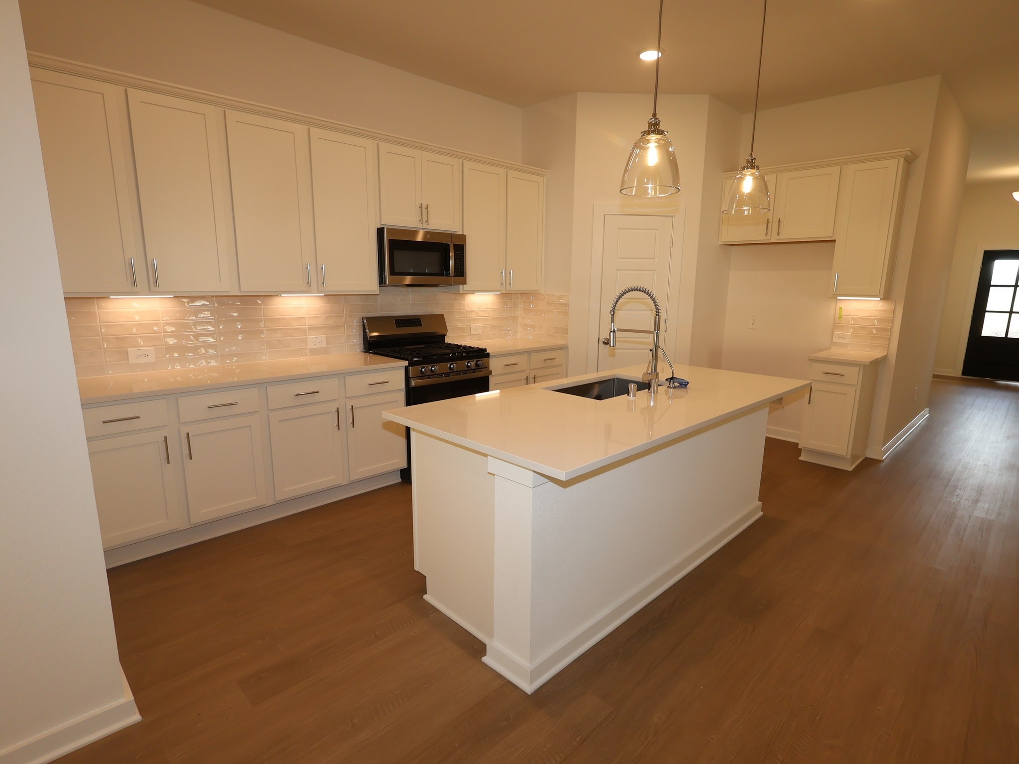 957 Garden Path Drive Willis, TX 77378 - Photo 2 of 37 a view of kitchen with stainless steel appliances granite countertop a sink a stove and a microwave