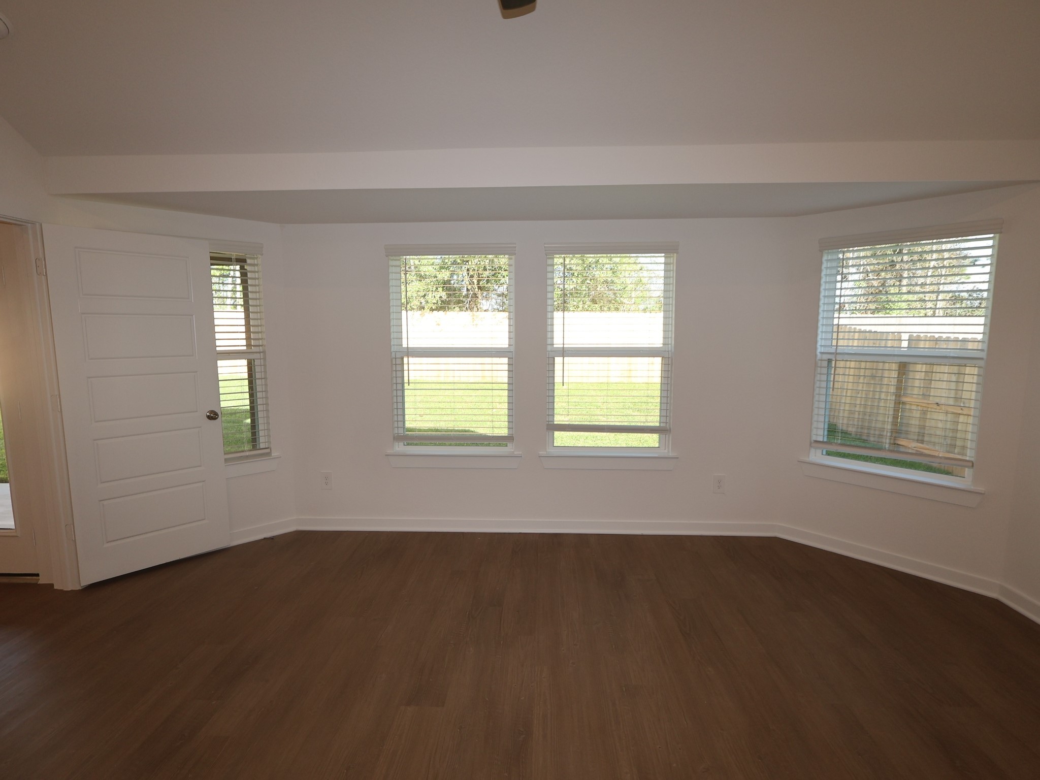 957 Garden Path Drive Willis, TX 77378 - Photo 4 of 37 a view of an empty room with wooden floor and a window