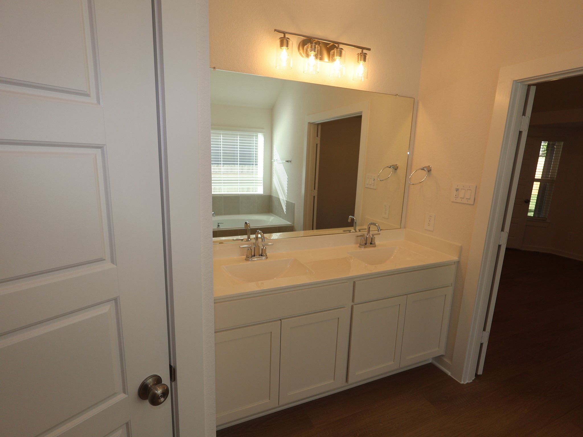 957 Garden Path Drive Willis, TX 77378 - Photo 5 of 37 a bathroom with a double vanity sink and mirror