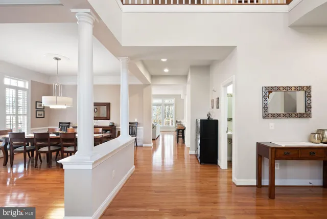 a living room with furniture a ceiling fan a flat screen tv and a potted plant