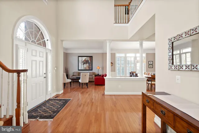 a living room with furniture a fireplace and a floor to ceiling window